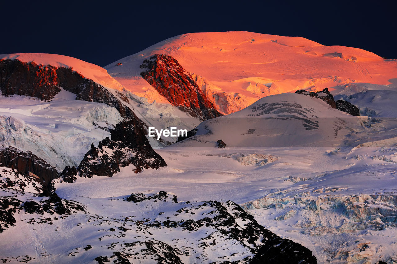 Scenic view of mountains against sky during winter