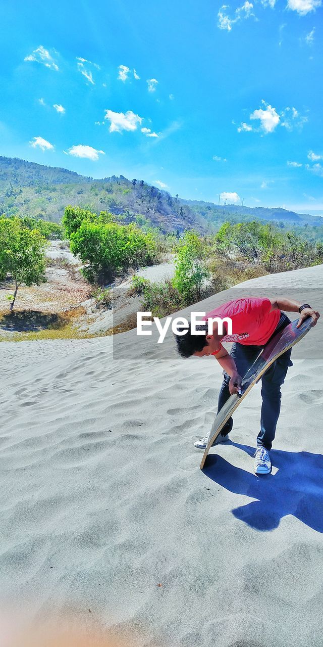 Man standing with sandboard