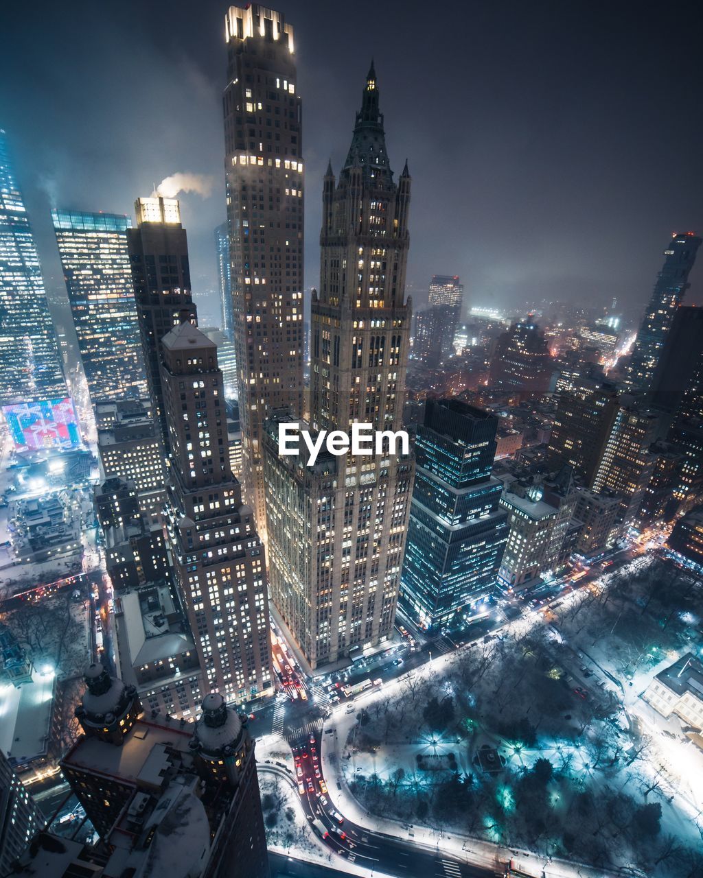 Aerial view of illuminated buildings in city at night