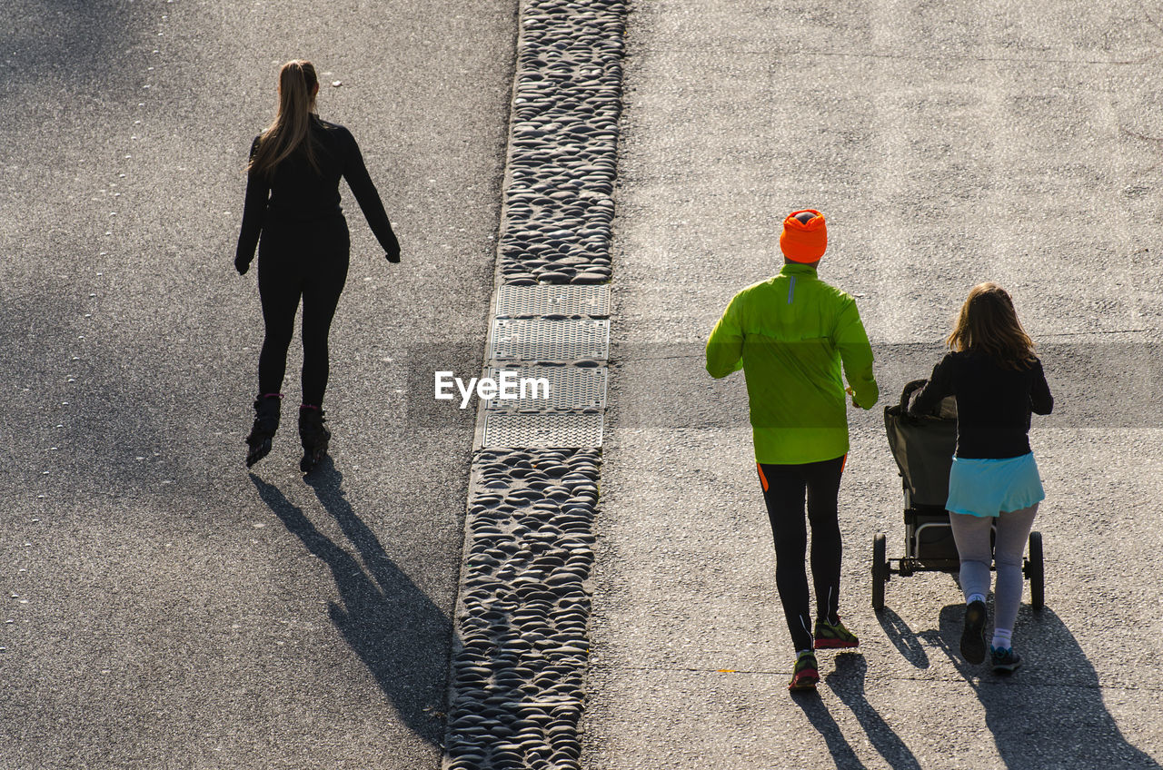 Rear view of people walking on street