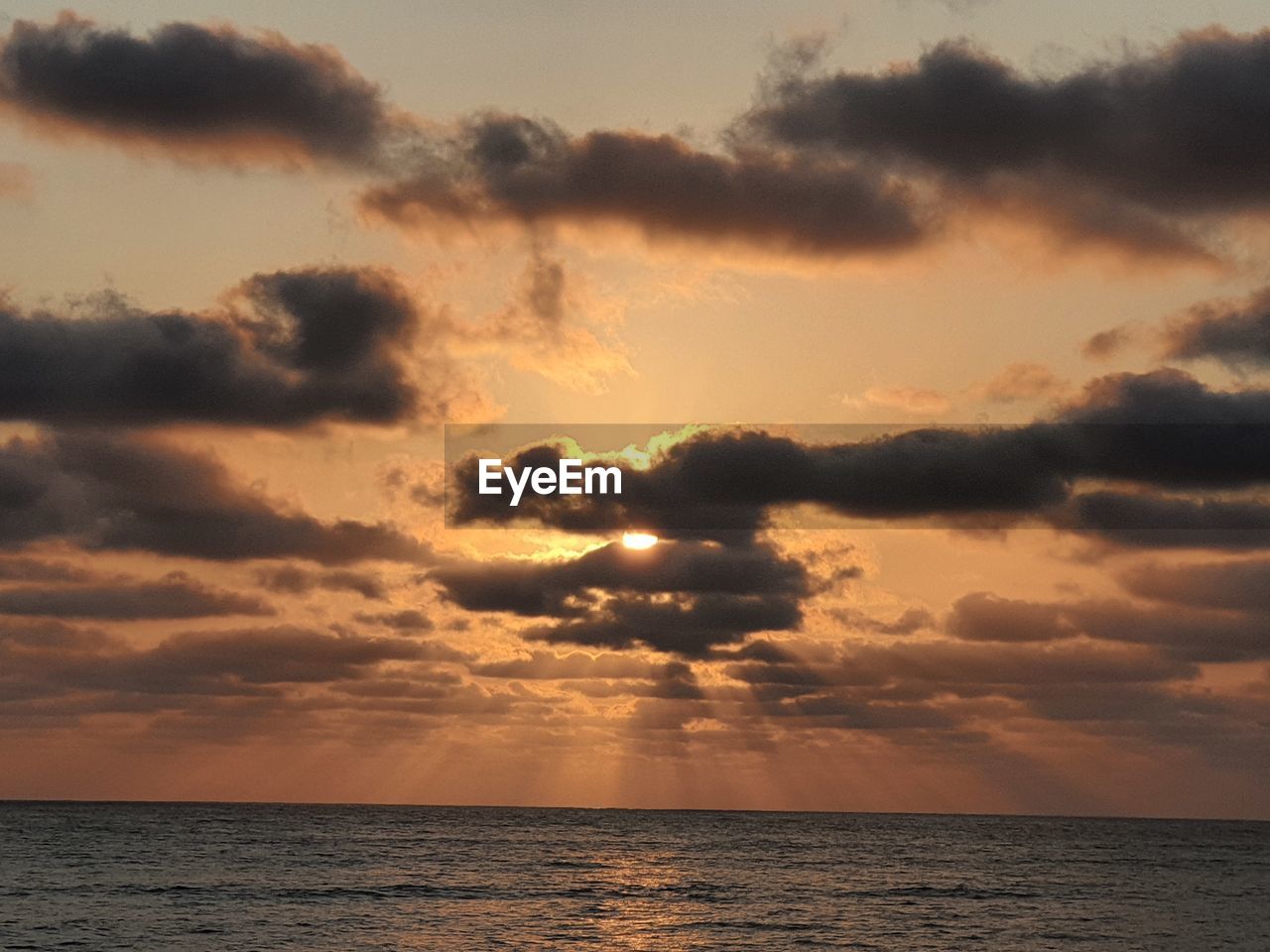 sky, sea, water, cloud, sunset, beauty in nature, horizon over water, scenics - nature, horizon, nature, dramatic sky, environment, tranquility, seascape, afterglow, tranquil scene, land, sunlight, idyllic, travel, cloudscape, holiday, no people, sun, beach, outdoors, vacation, storm, trip, dusk, ocean, travel destinations, urban skyline, orange color, evening, coast, awe, atmospheric mood, summer, landscape, tropical climate, sunbeam, reflection, shore, tourism, multi colored, red sky at morning, backgrounds, moody sky, religion