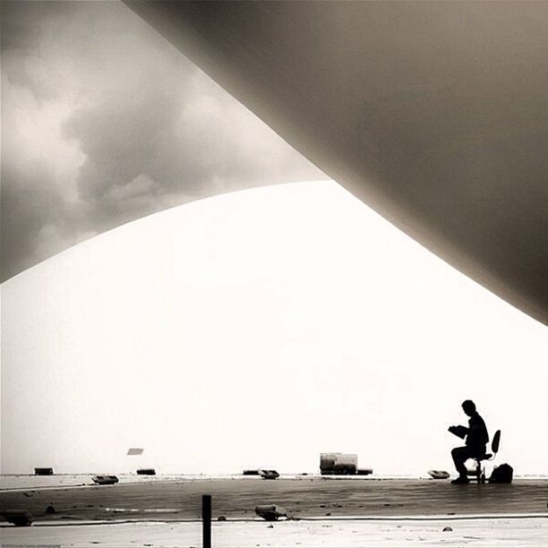 LOW ANGLE VIEW OF WOMAN STANDING AGAINST SKY