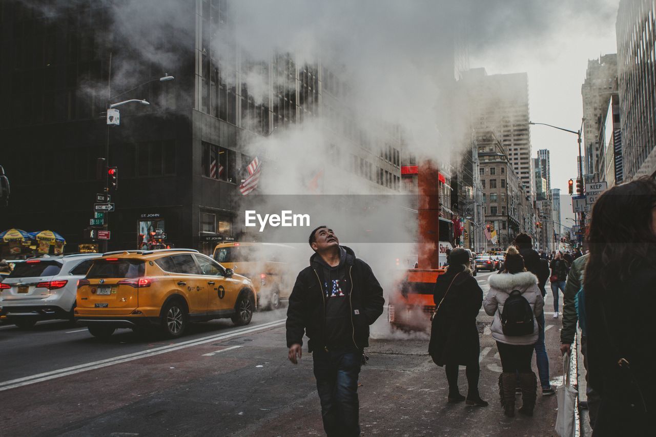 MAN STANDING ON STREET AGAINST CITY