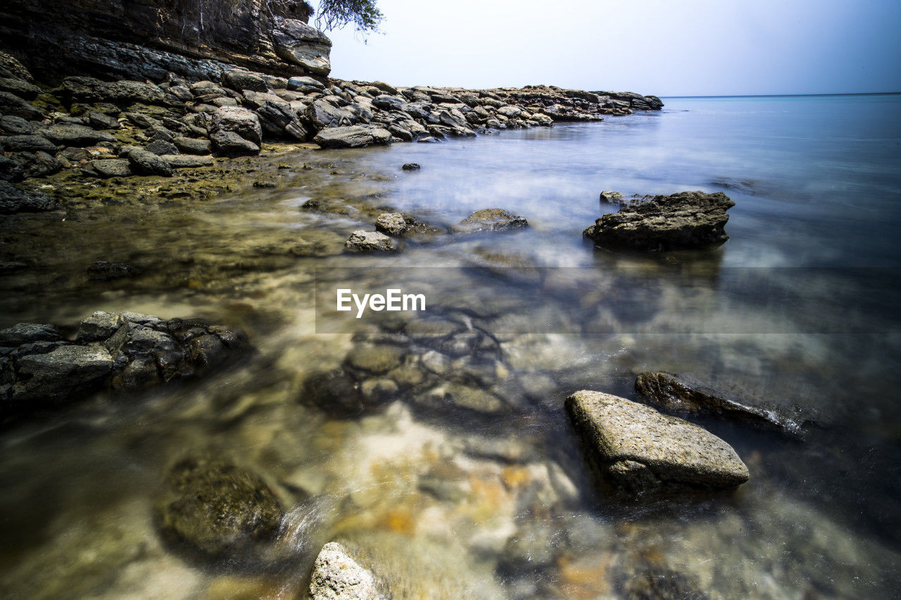 water, rock, nature, sea, reflection, beauty in nature, land, scenics - nature, sky, coast, no people, ocean, tranquility, wave, beach, shore, sunlight, body of water, motion, tranquil scene, outdoors, day, environment, morning, long exposure, non-urban scene, idyllic, stone, travel destinations
