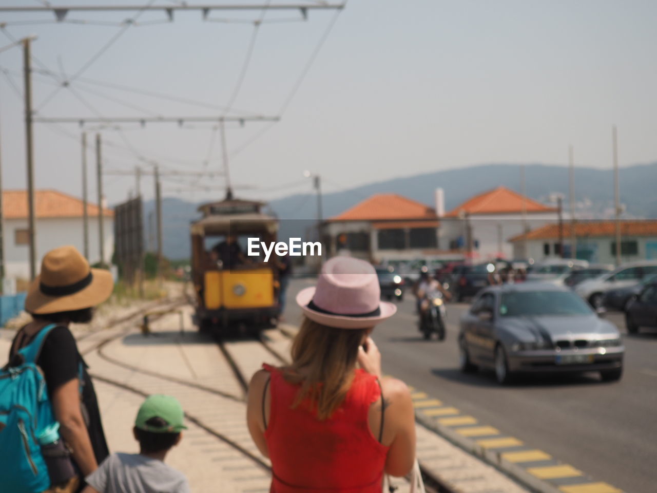 REAR VIEW OF WOMAN ON BUS IN CITY