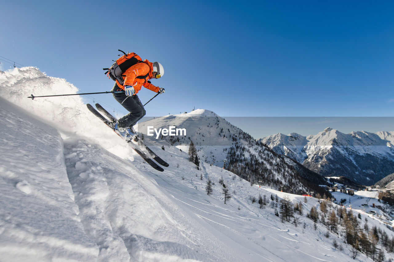 Off-piste skier near a ski resort in the italian alps