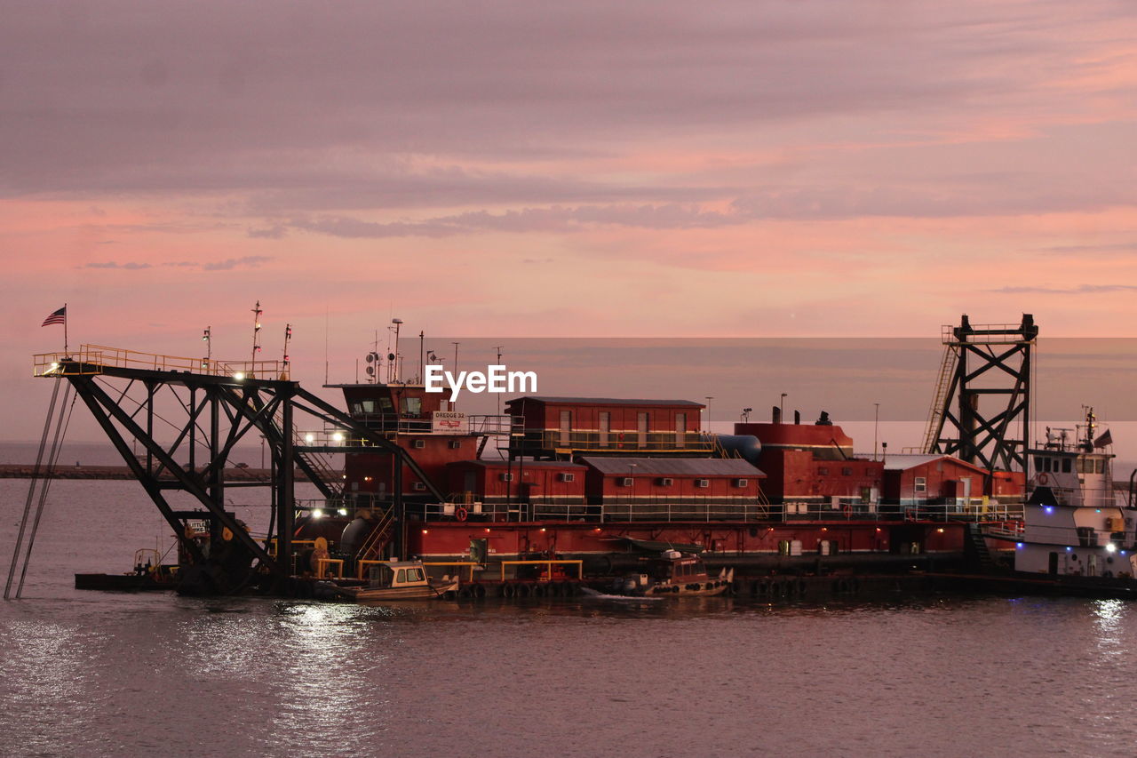 COMMERCIAL DOCK AGAINST SKY AT SUNSET