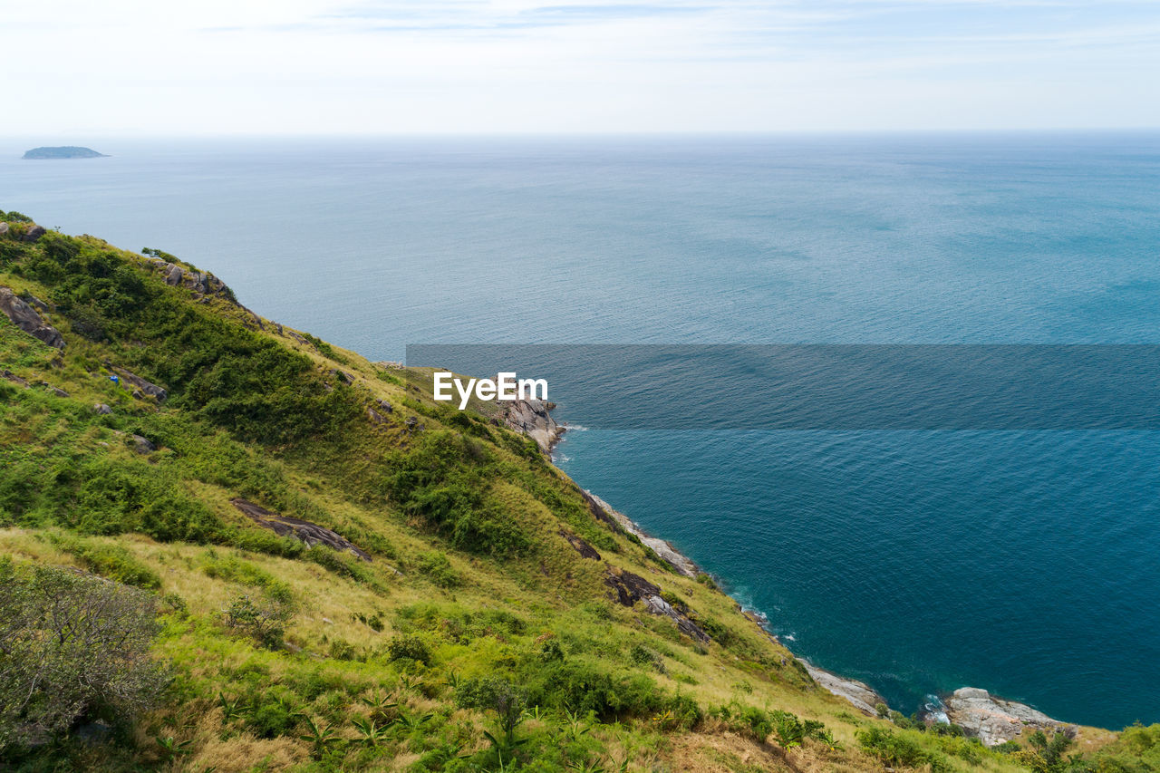 HIGH ANGLE VIEW OF SEA AND ROCKS AGAINST SKY