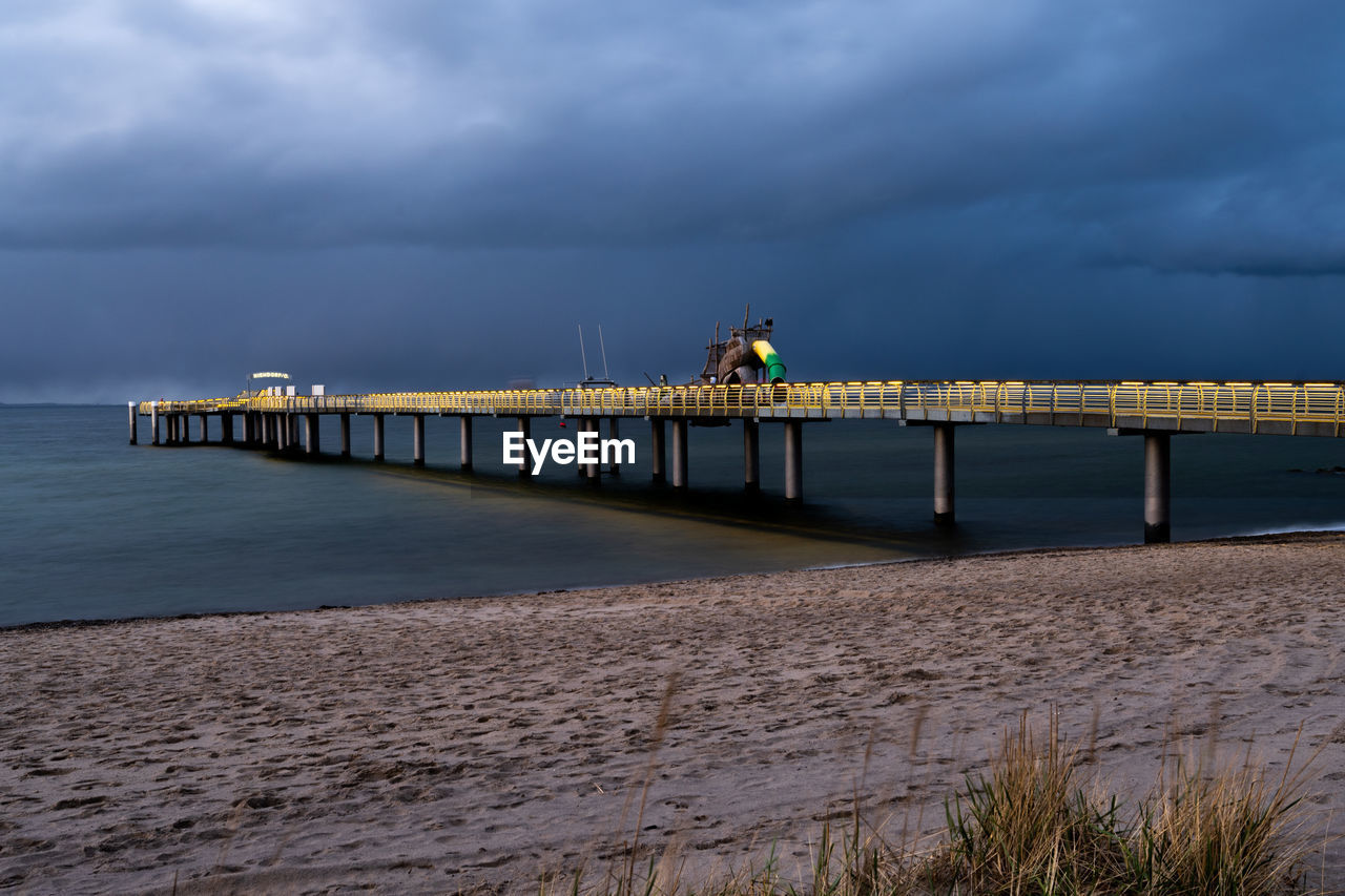 Pier over sea against sky