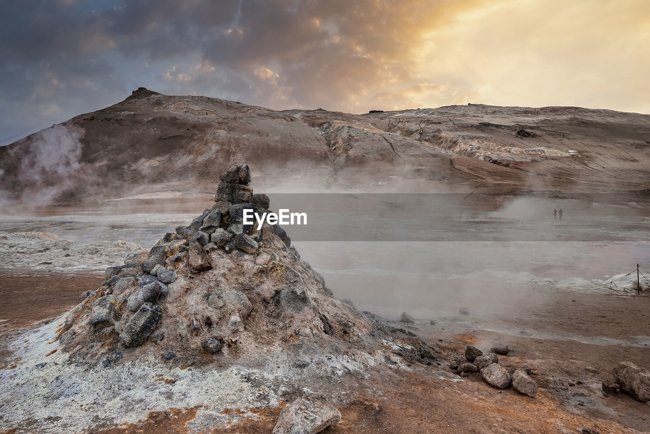 View of steaming fumarole in geothermal area of hverir at namafjall at sunset