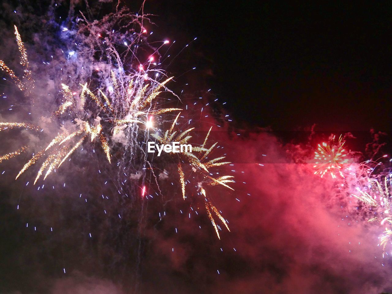 Low angle view of fireworks exploding in night sky