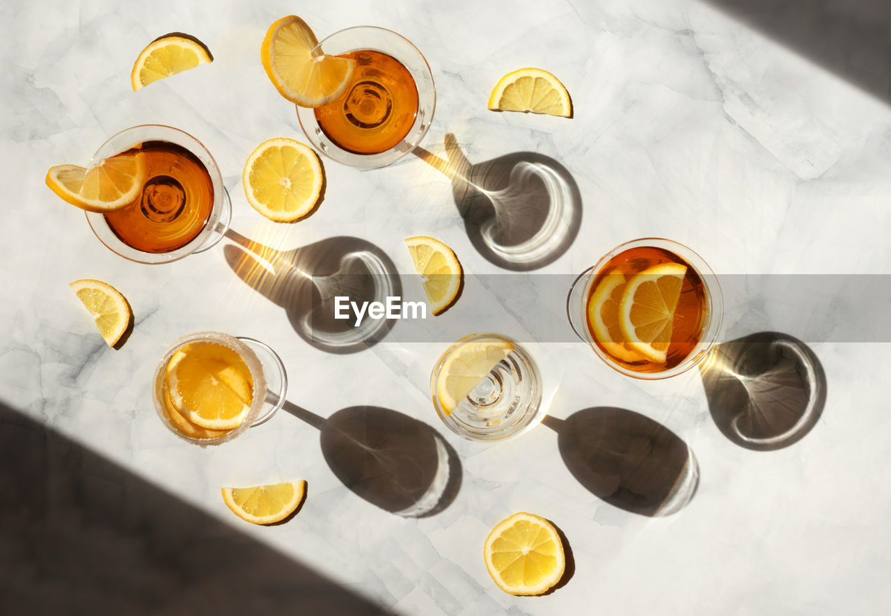 Summer cocktails in the sunlight. fresh beverages in glasses with shadows making trendy pattern