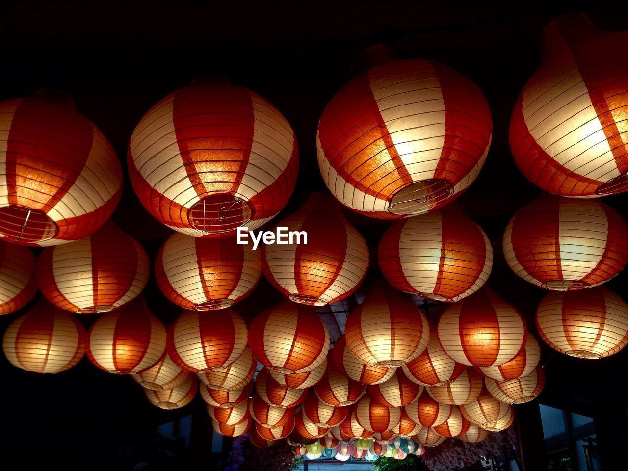 Low angle view of illuminated lanterns hanging on ceiling