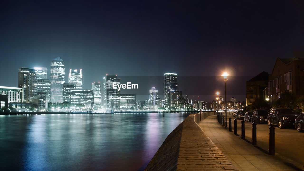 Illuminated cityscape against clear sky at night