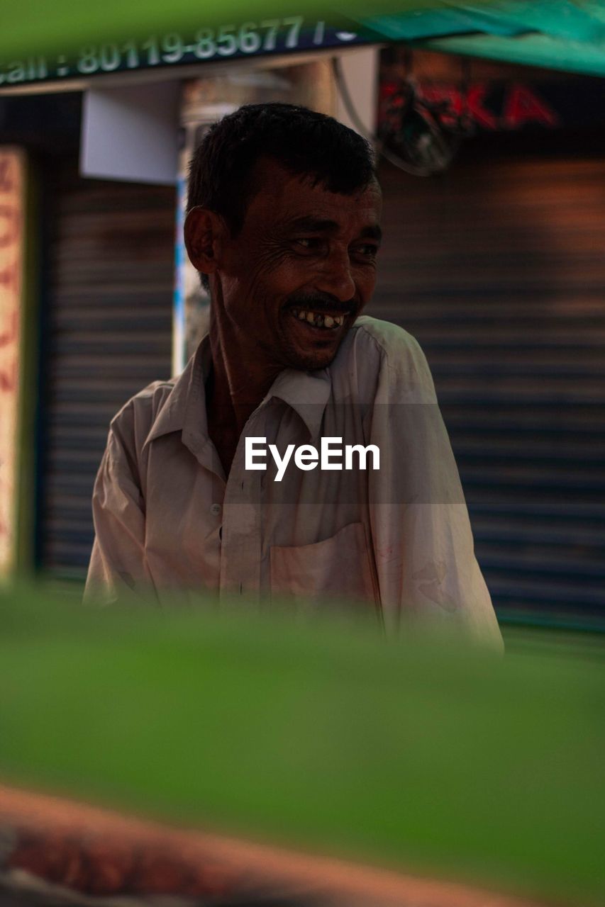 Portrait of a smiling old man looking away