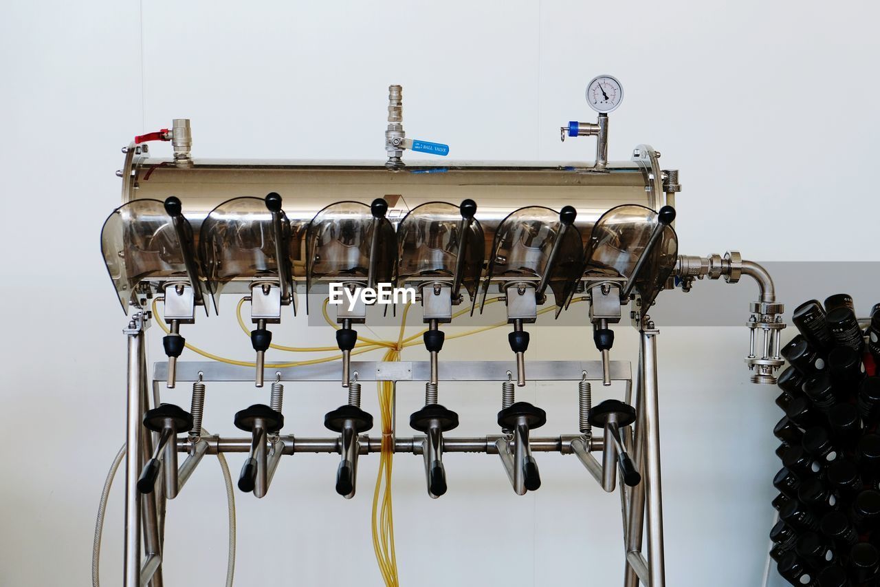 Close-up of bottle filling machine in industry