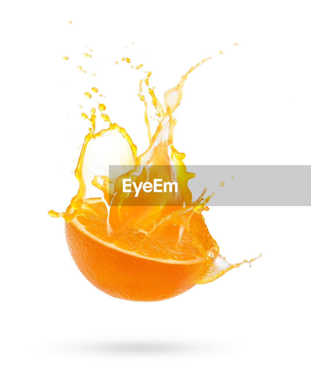 Close-up of orange splashing against white background