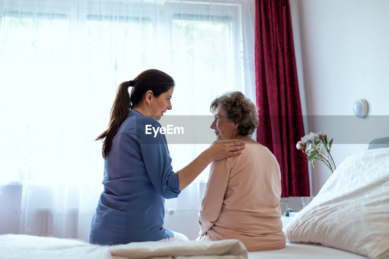Doctor talking with patient in hospital