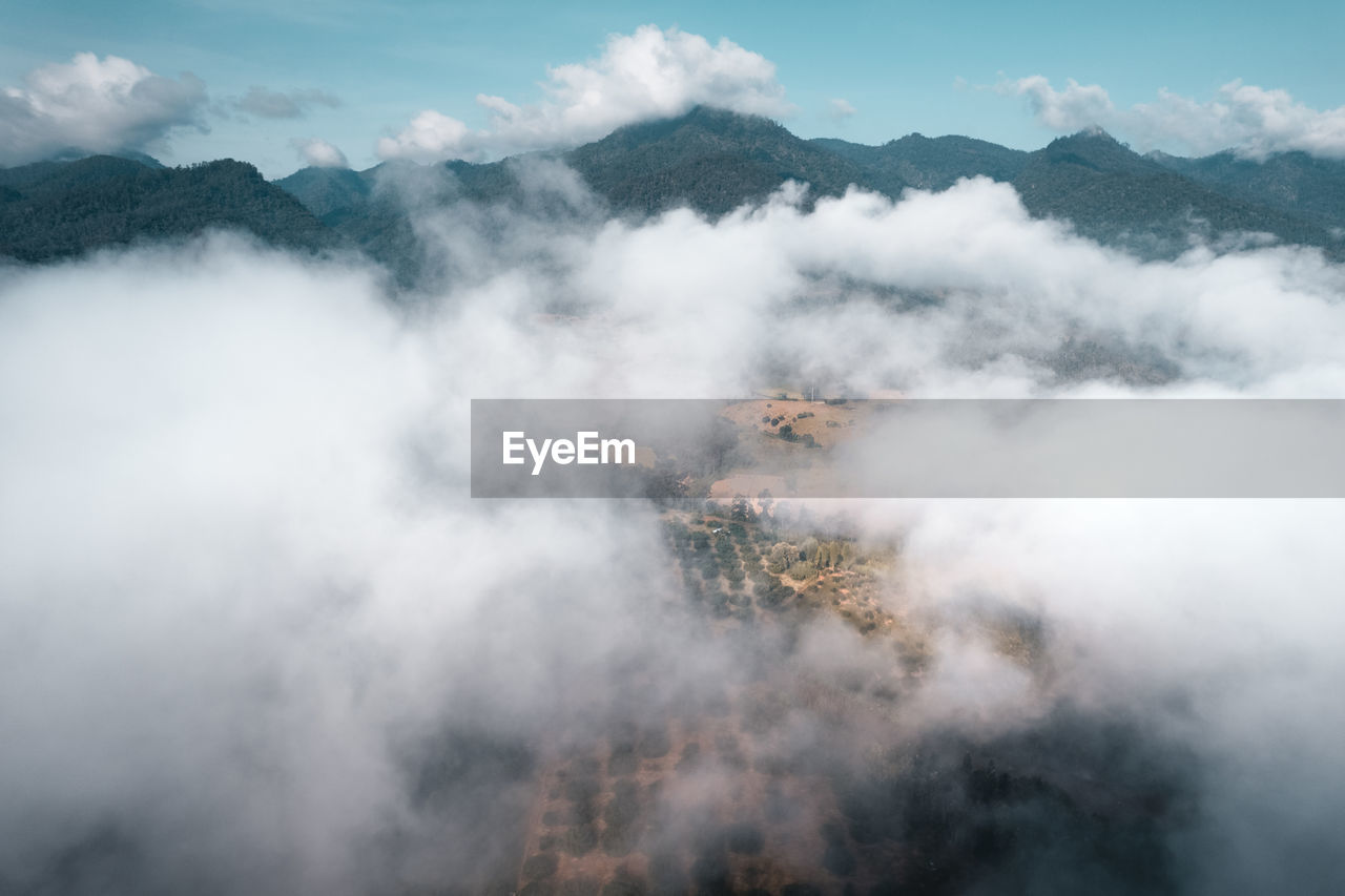 Smoke emitting from volcanic mountain against sky