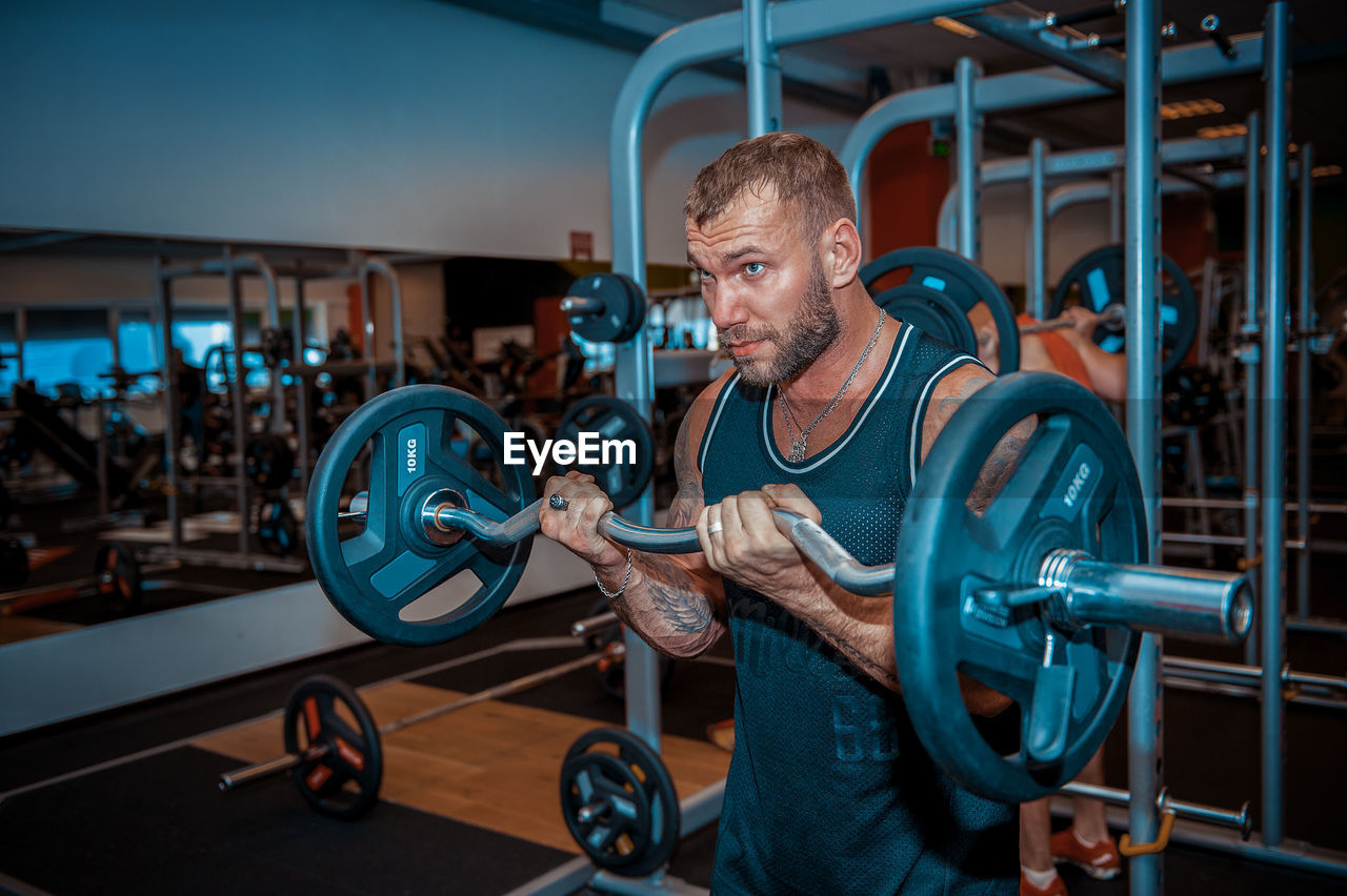 Muscular man exercising in gym