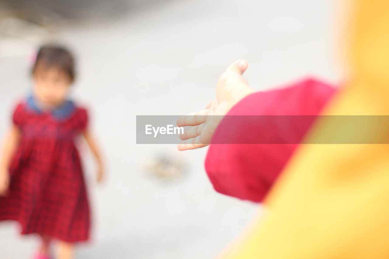 Close-up of mother hand reaching for daughter