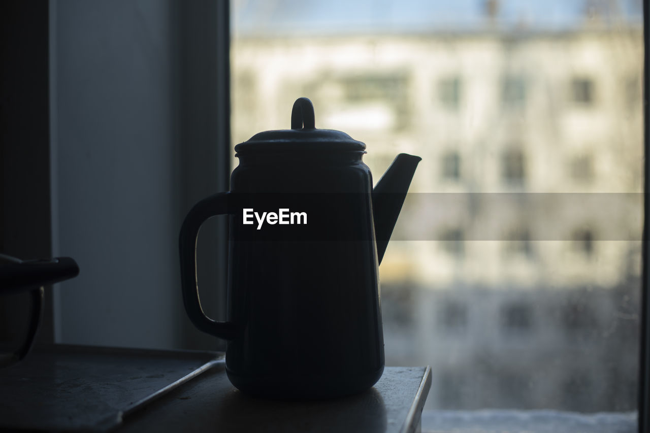 black, teapot, kettle, window, indoors, table, drink, cup, mug, no people, focus on foreground, iron, food and drink, hot drink, lighting, still life, tea, day, refreshment, still life photography, close-up, white, domestic room, glass, home interior, coffee, household equipment