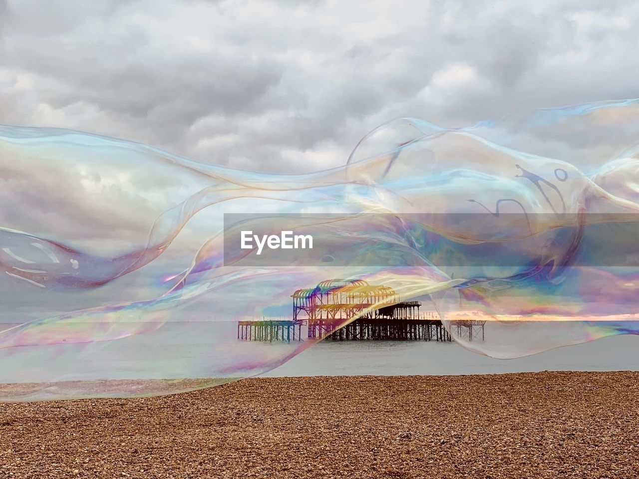 Large bubble at beach against sky