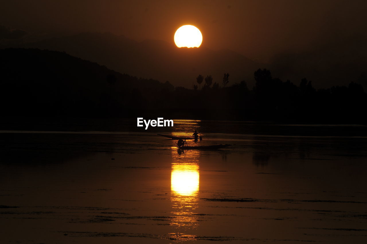 SCENIC VIEW OF LAKE AGAINST ORANGE SKY