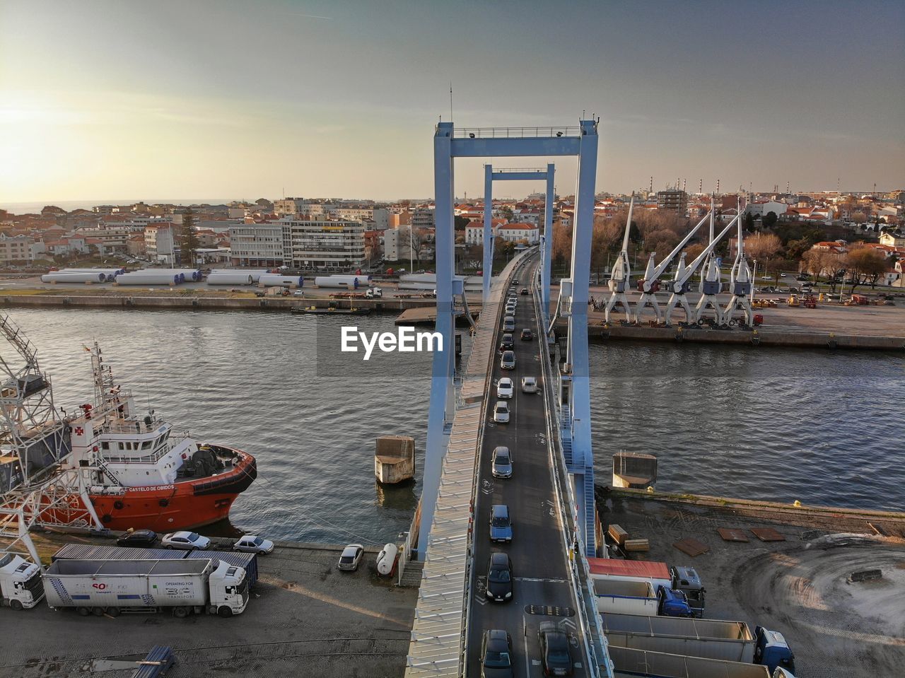 HIGH ANGLE VIEW OF BRIDGE OVER RIVER AGAINST SKY