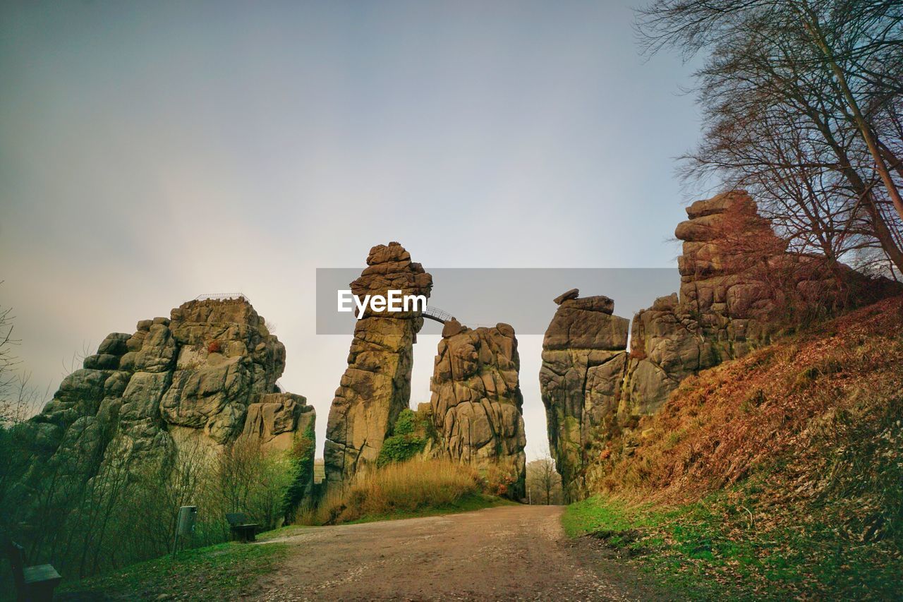 LOW ANGLE VIEW OF ROCK FORMATIONS ON LANDSCAPE AGAINST SKY