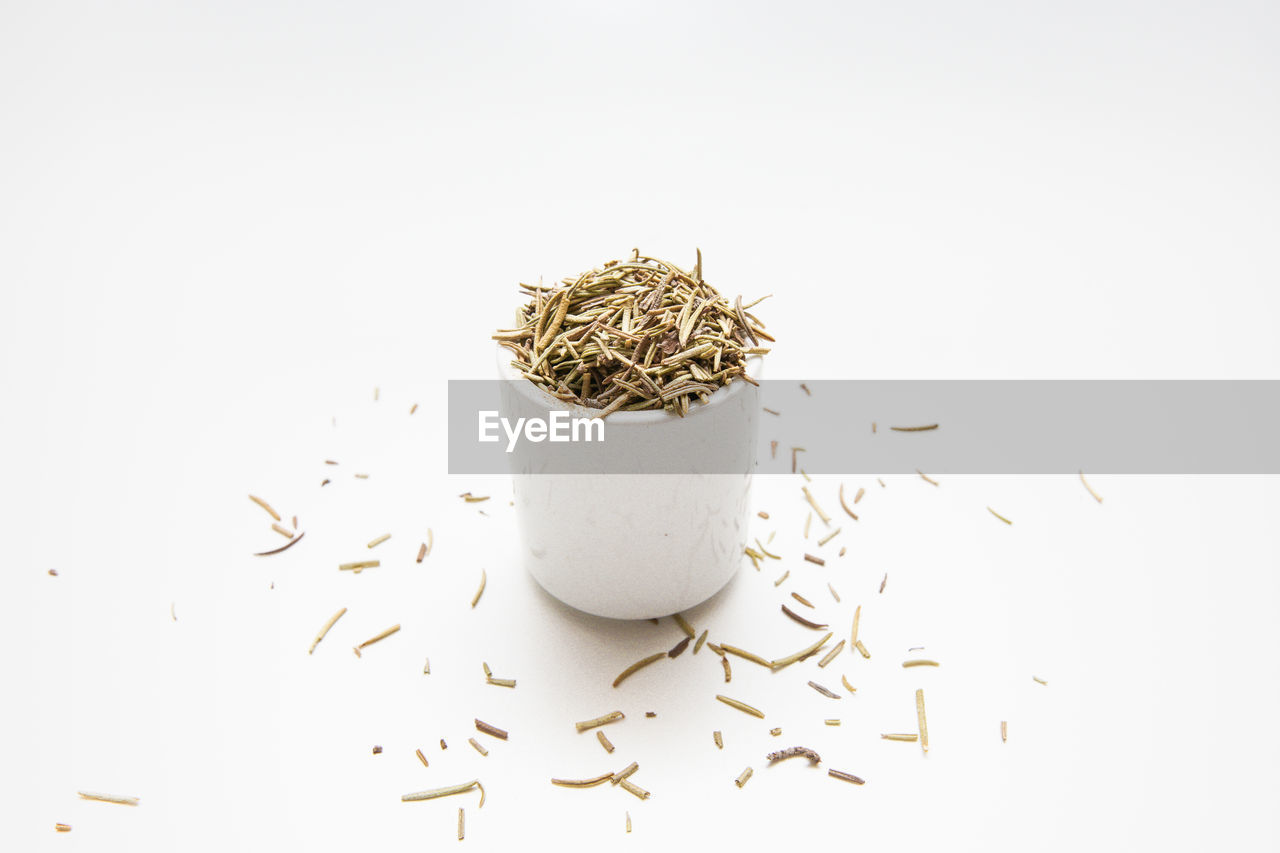 Dried rosemary leaves - rosmarinus officinalis isolated on white background.