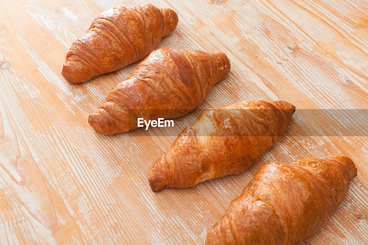 Croissants on light wooden surface