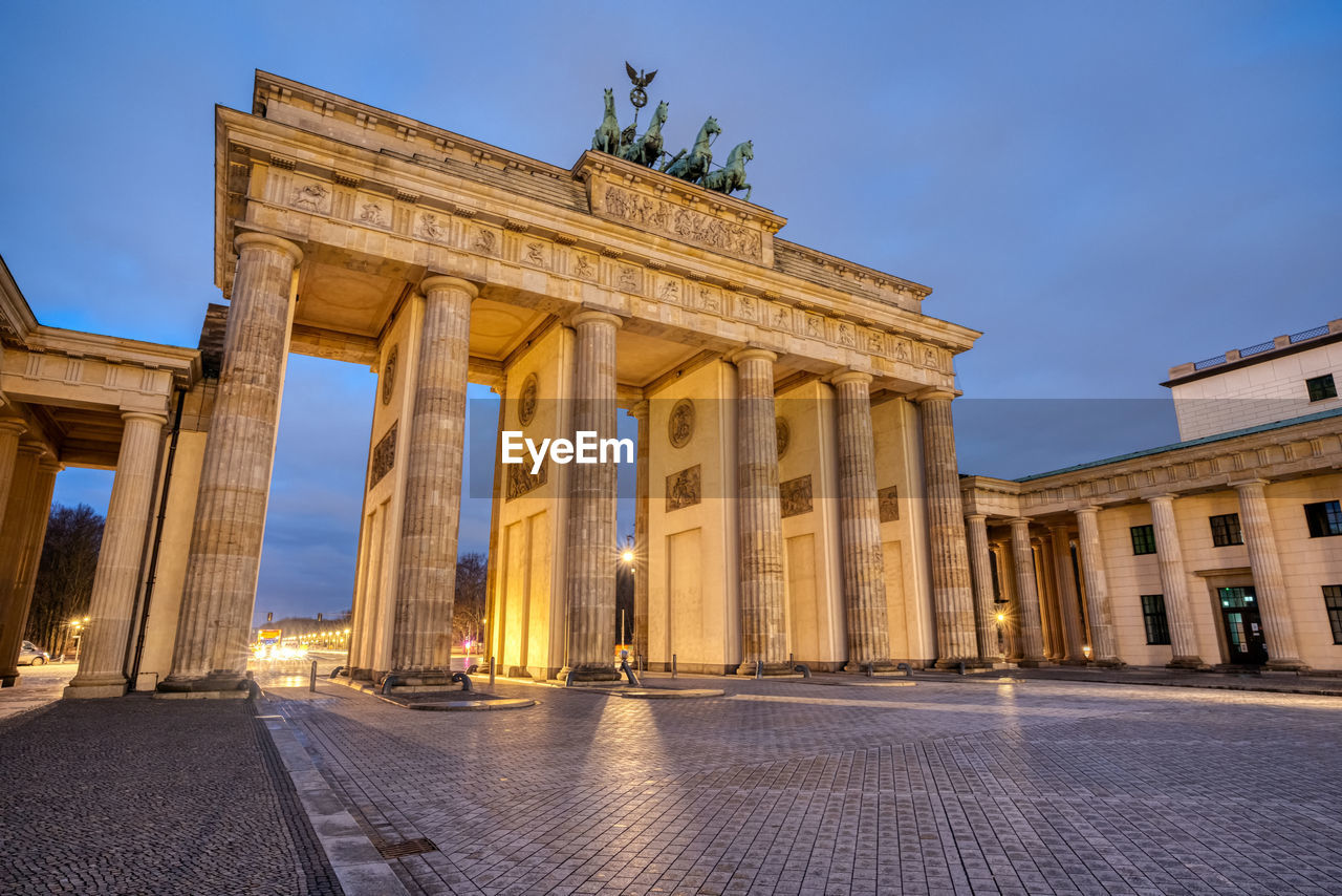 The famous brandenburg gate in berlin at dawn