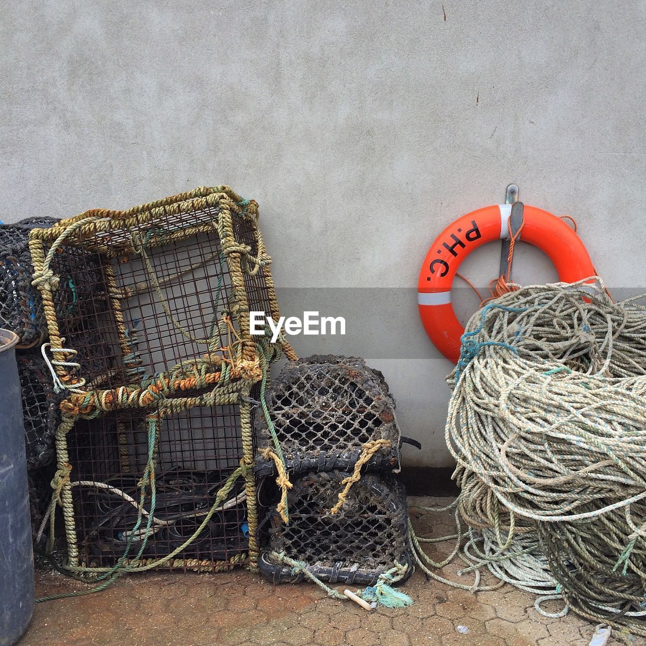 Life belt and rope stack against wall at padstow