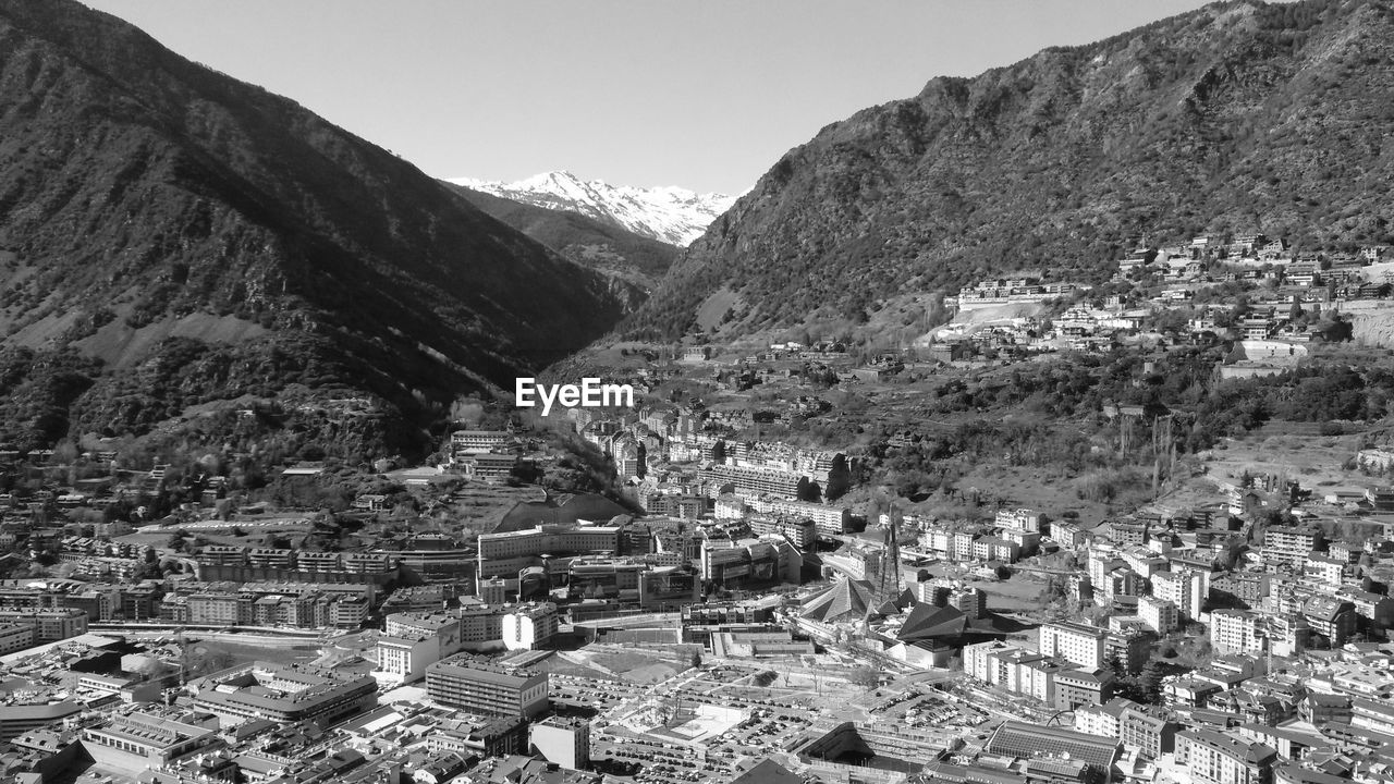 High angle view of townscape and mountains against sky