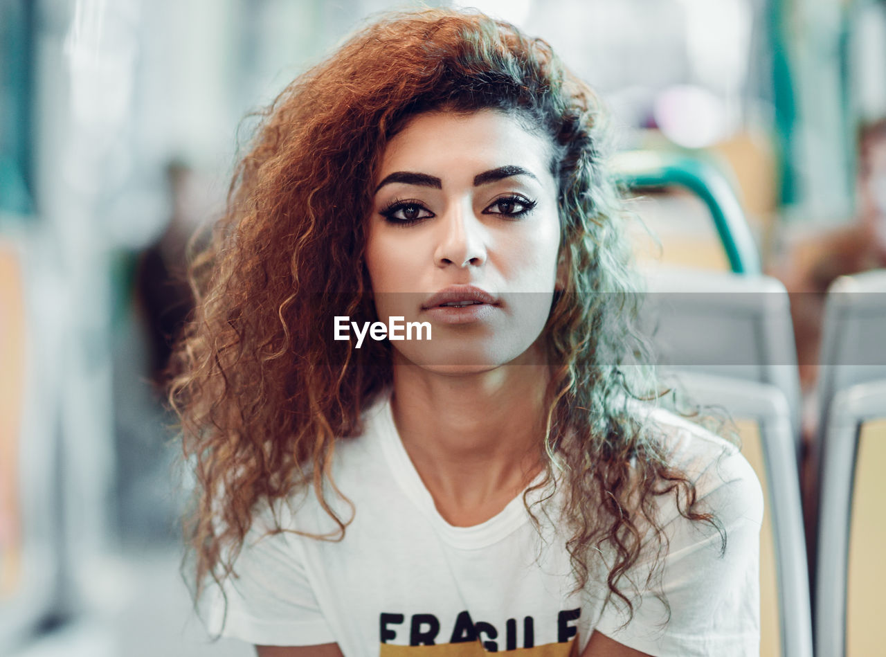 Portrait of young woman traveling in train