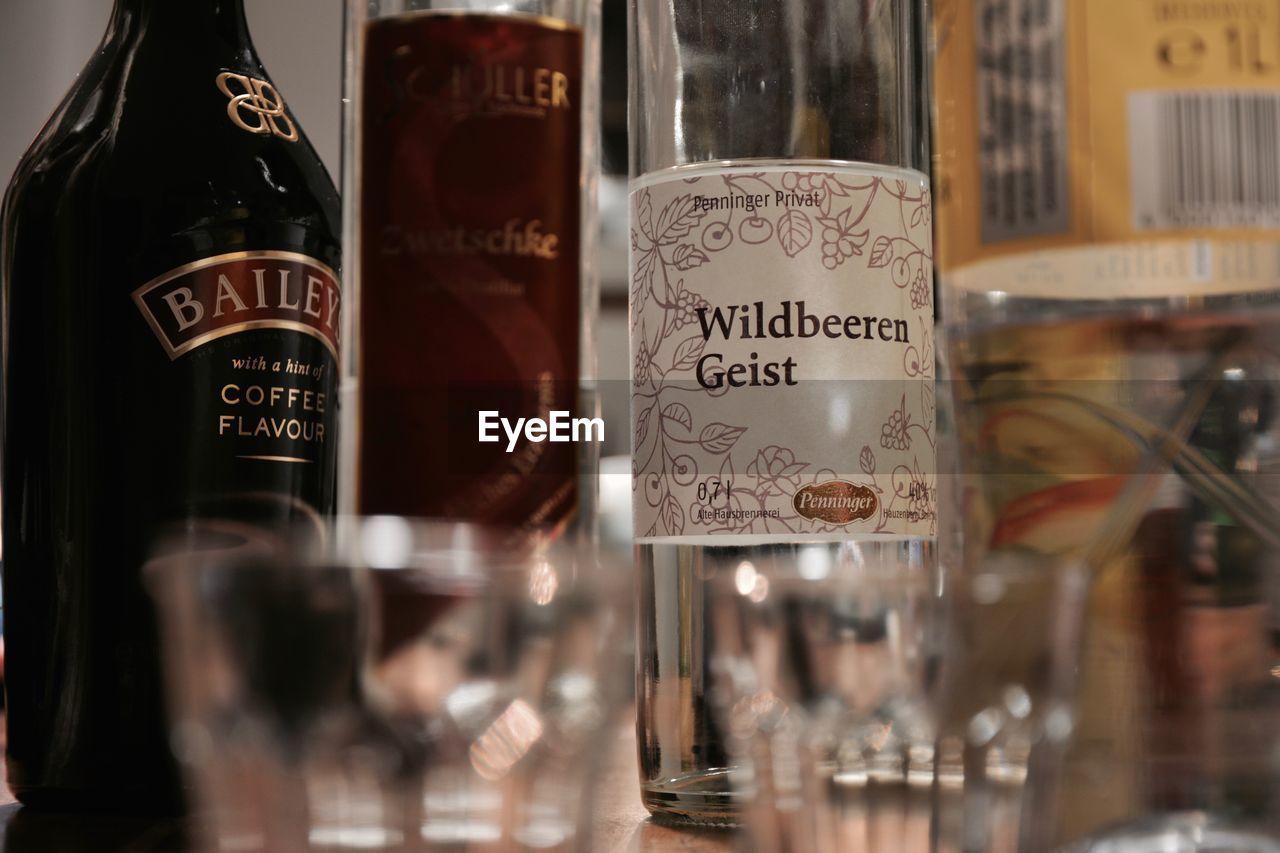 CLOSE-UP OF WINE BOTTLES ON GLASS