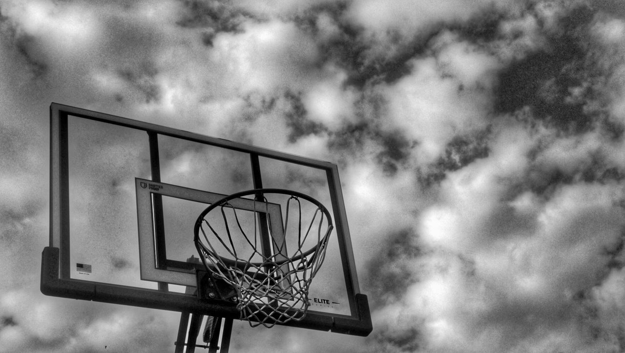 Low angle view of basketball hoop against cloudy sky