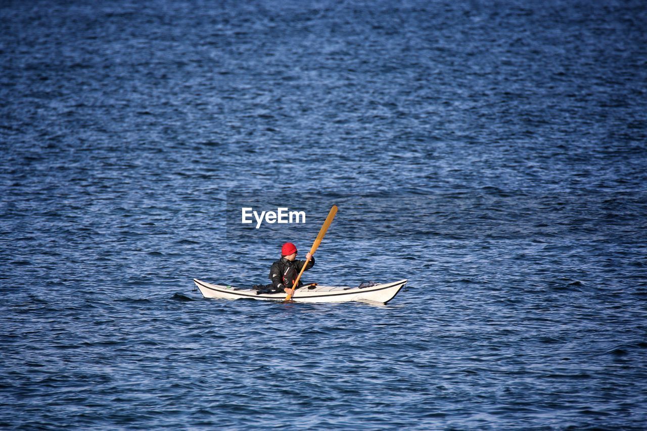 Person sailing kayak in baltic sea