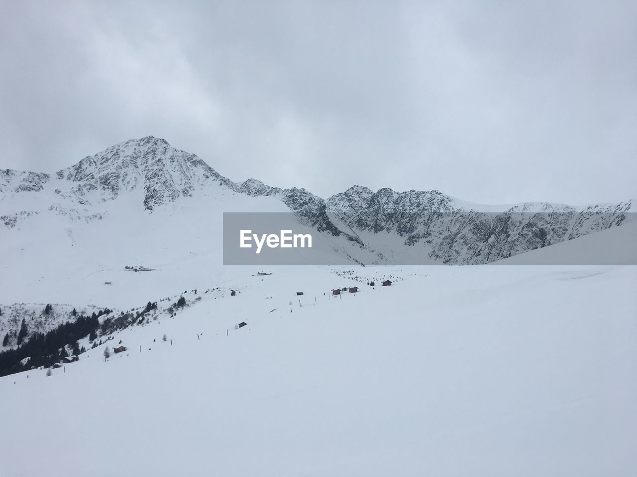 SNOW COVERED MOUNTAINS AGAINST SKY