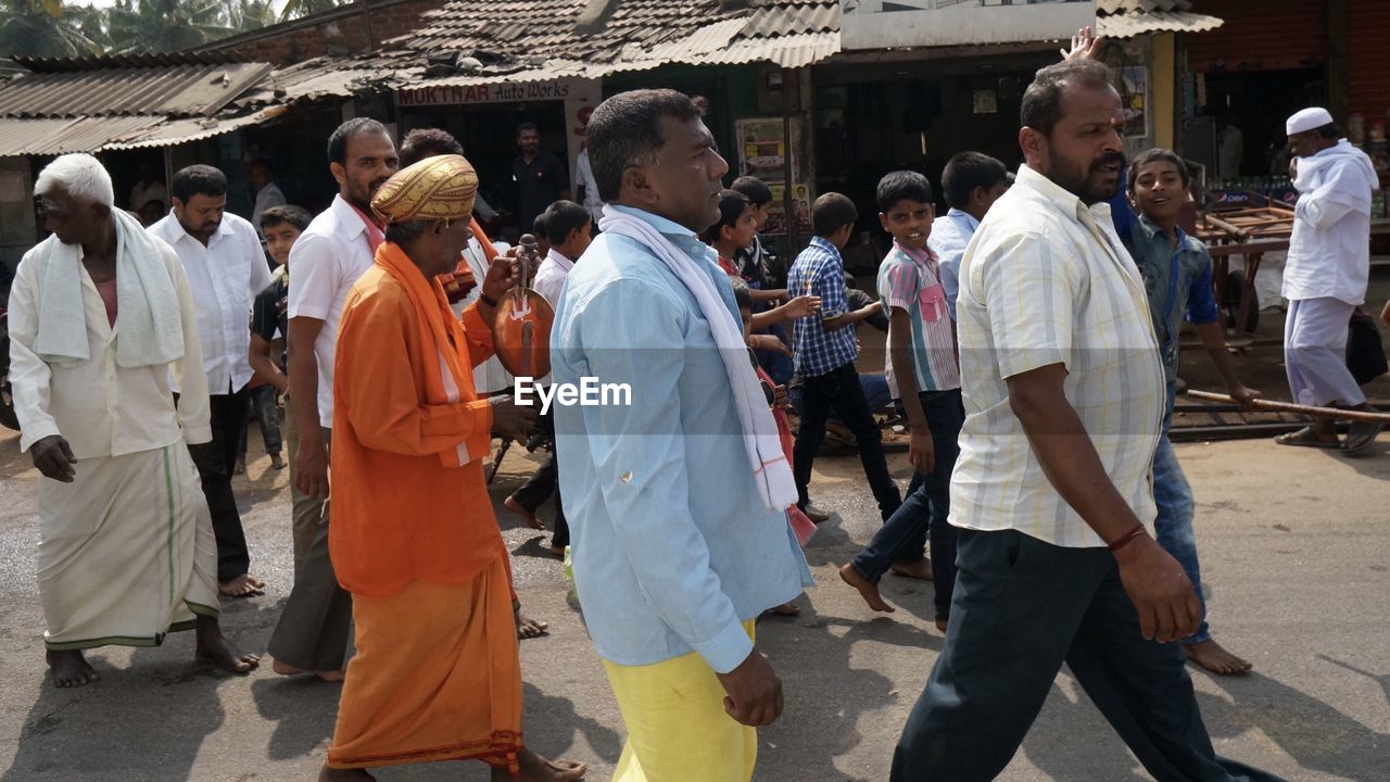 PEOPLE STANDING AT TEMPLE AGAINST CATHEDRAL