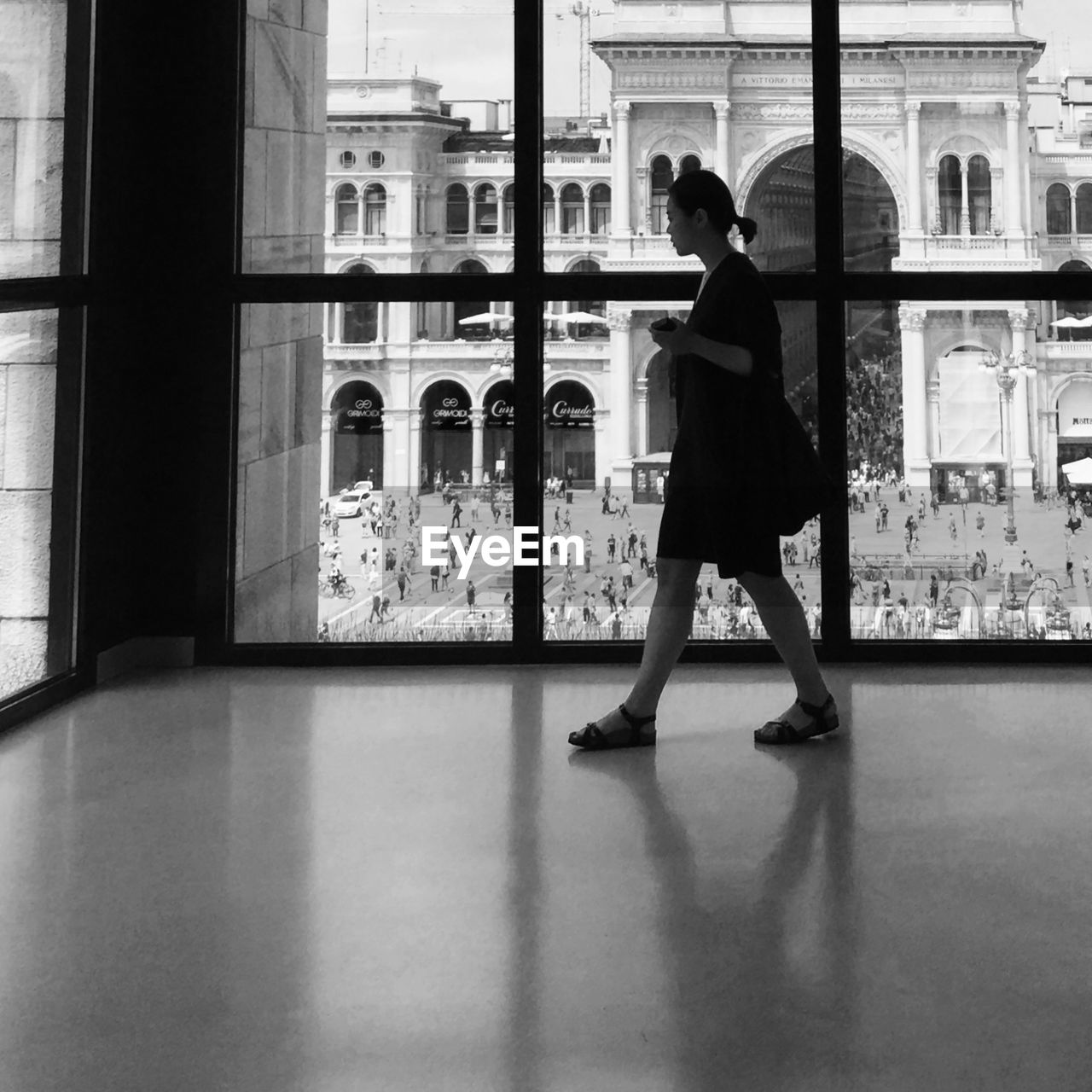 WOMAN STANDING IN FRONT OF BUILDING