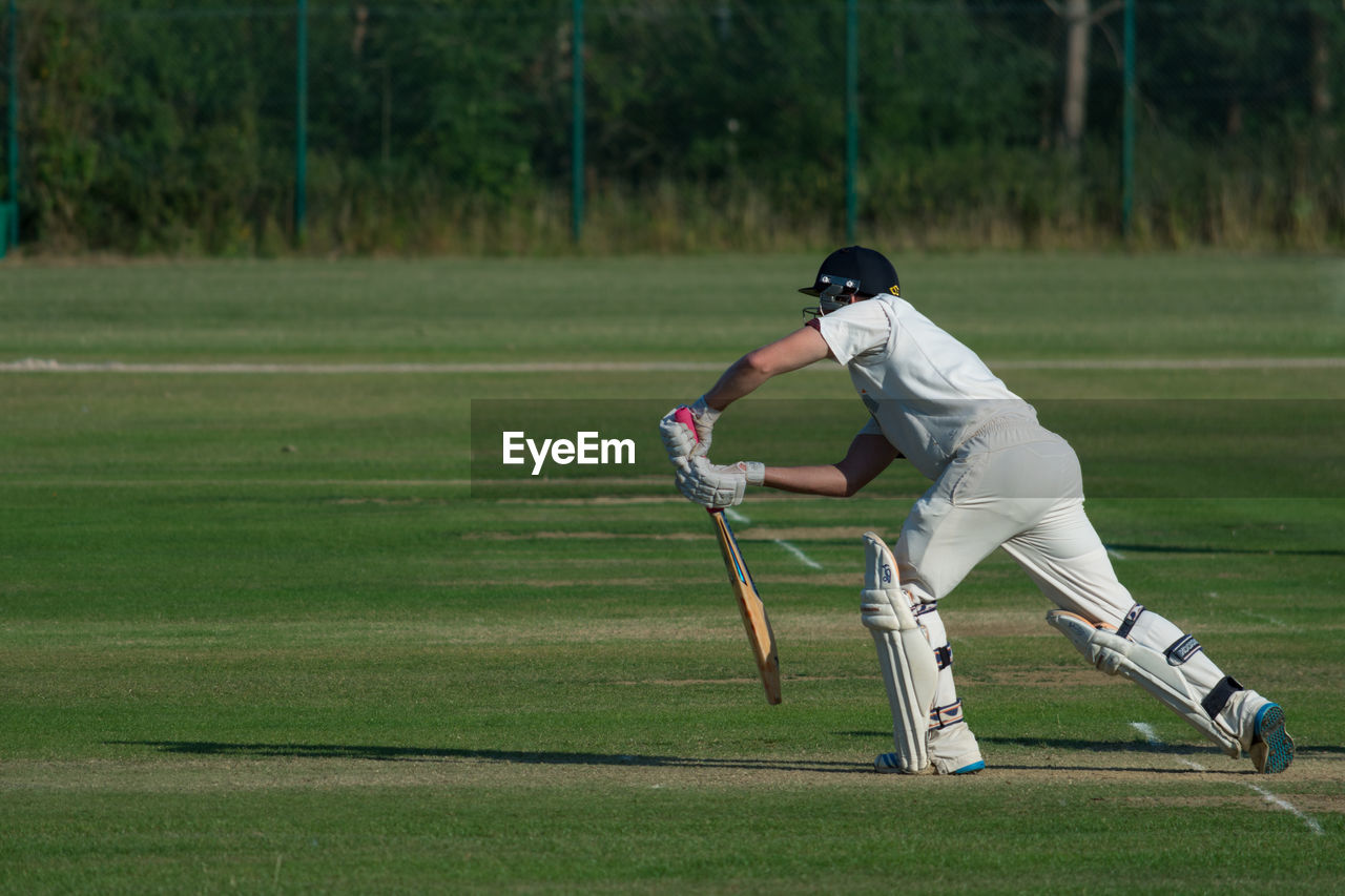 Man playing cricket in stadium