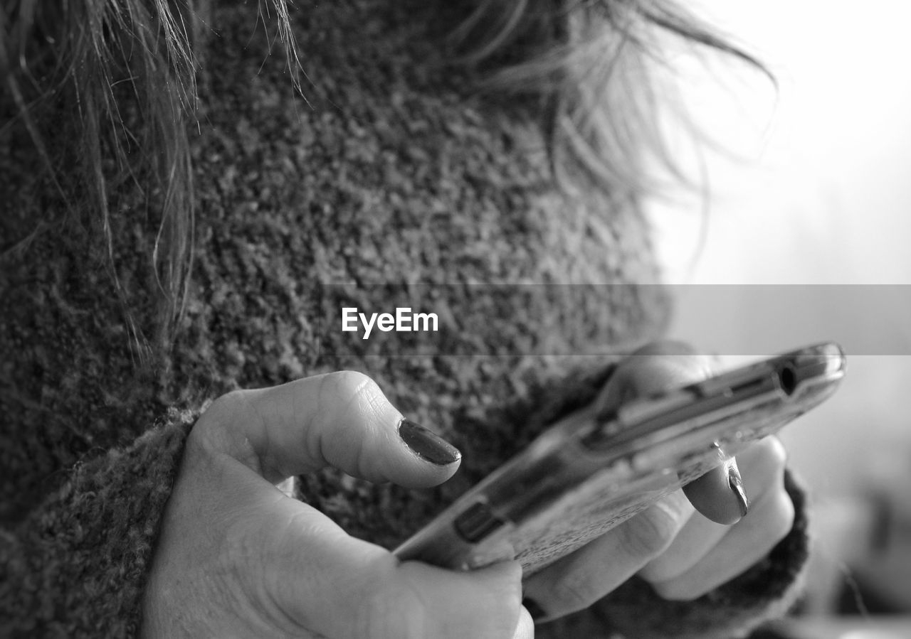Midsection of woman using mobile phone