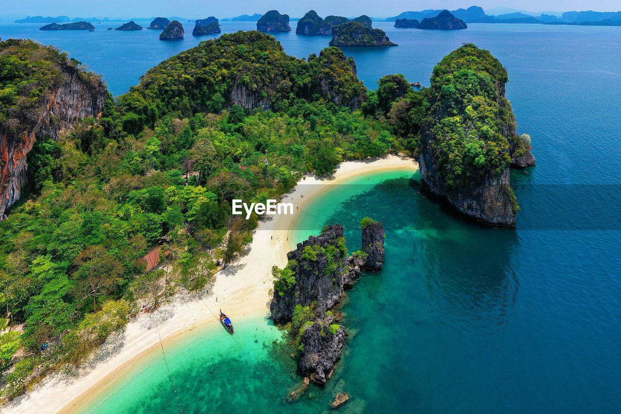 HIGH ANGLE VIEW OF BAY AGAINST TREES