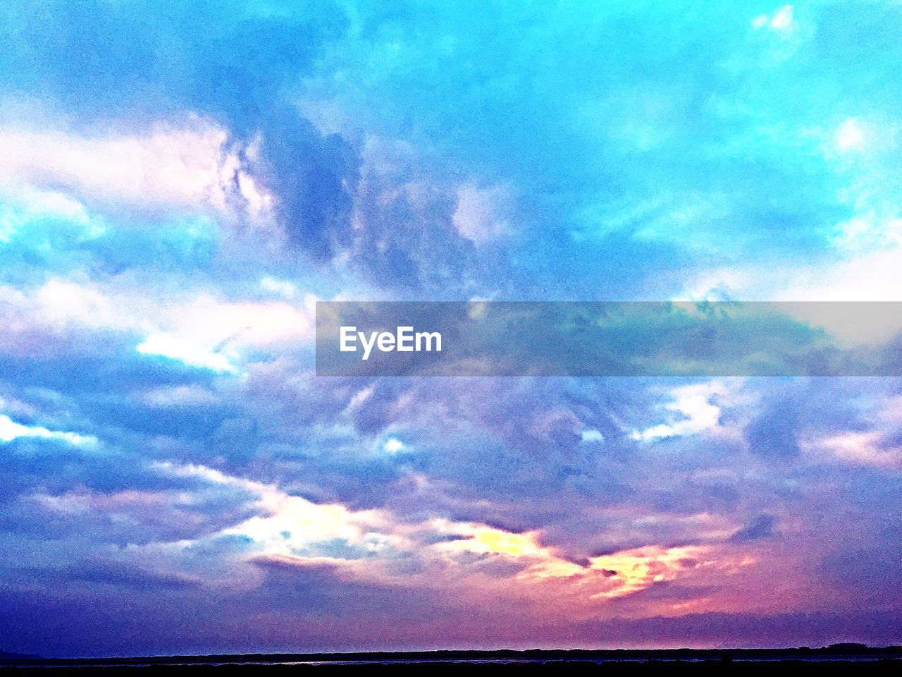 Low angle view of cloudy sky during sunset