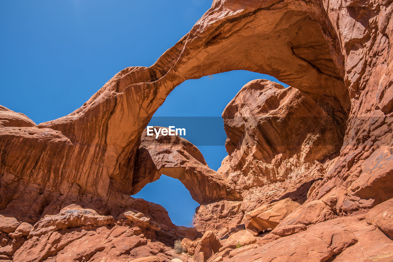 Low angle view of rock formation against clear sky