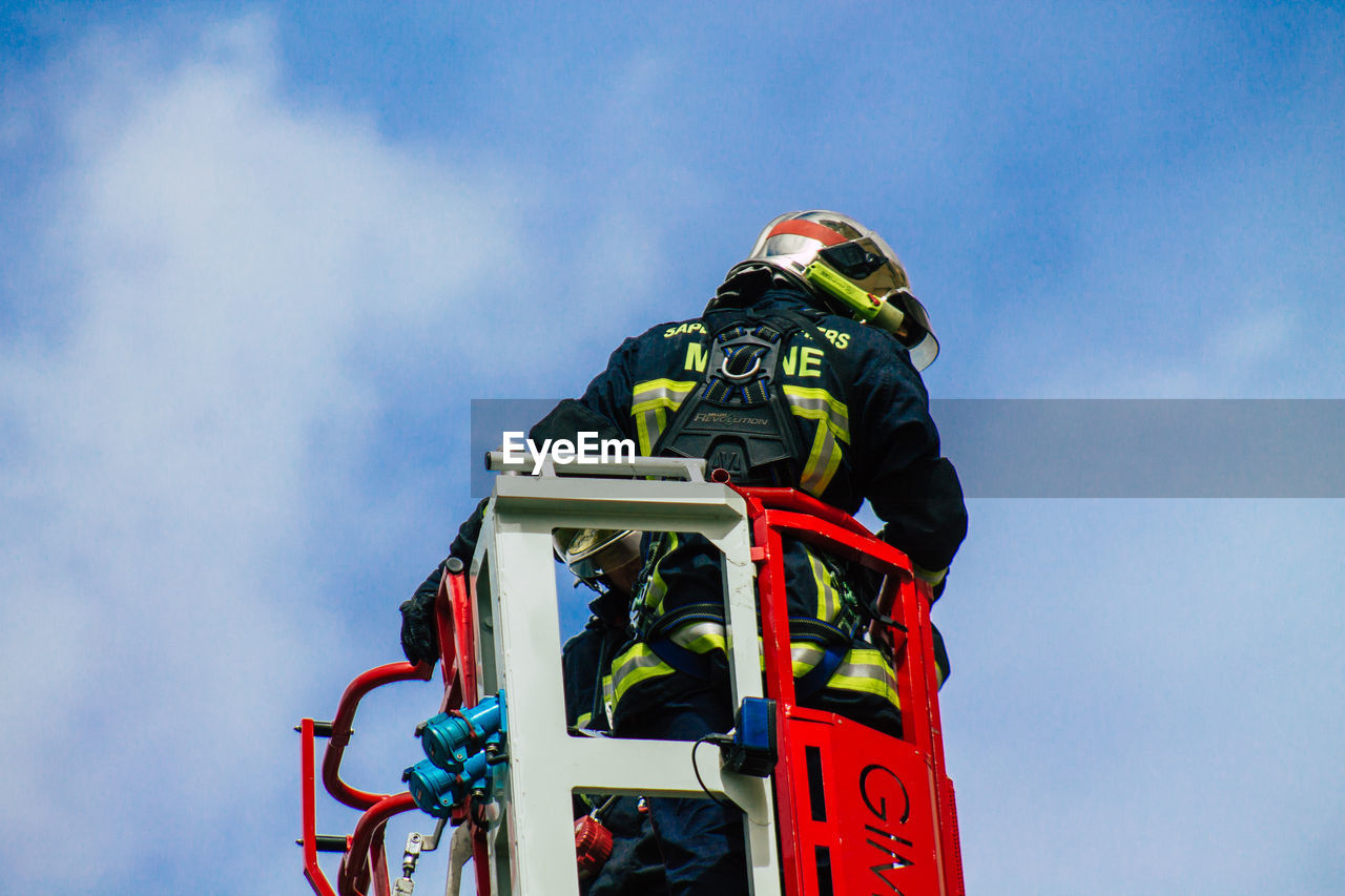 LOW ANGLE VIEW OF PERSON WORKING IN TRADITIONAL WINDMILL