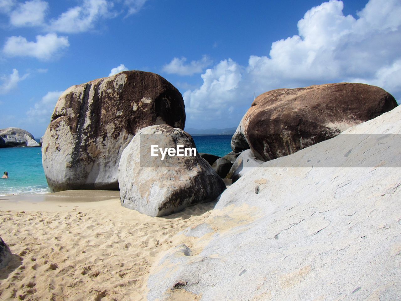 Rocks on beach against sky