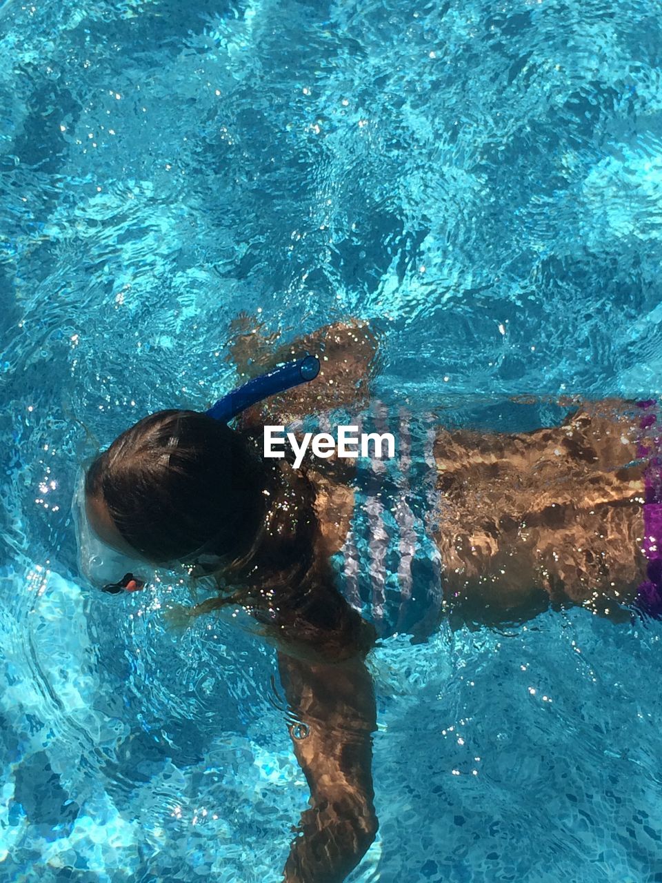 High angle view of boy swimming in pool